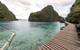 A wooden bridge that leads to the entrance of Kayangan Lake, a must-see stop on this private Coron island hopping tour A with port pick-up