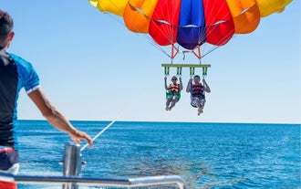 Friends share a thrilling moment in this private parasailing activity in Boracay Island, which is ideal for cruise passengers.