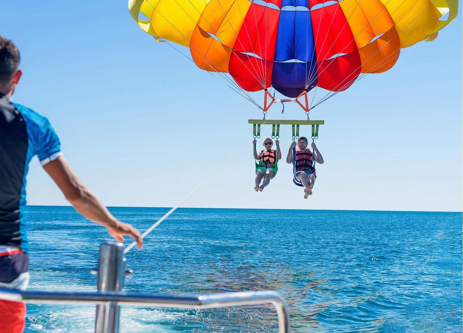 Friends share a thrilling moment in this private parasailing activity in Boracay Island, which is ideal for cruise passengers.