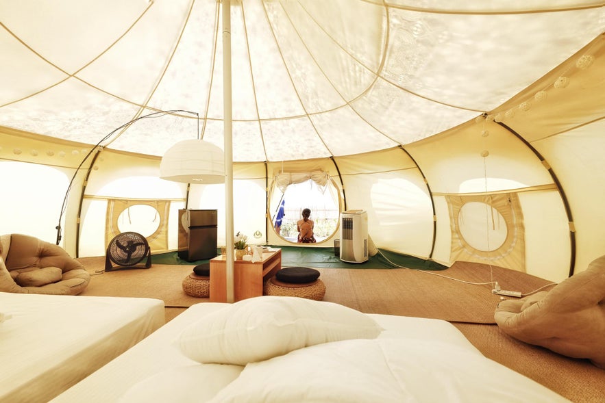 Comfortable and spacious glamping tent surrounded by palm trees at Nacpan Beach in El Nido, Palawan Comfortable and spacious glamping tent surrounded by palm trees at Nacpan Beach in El Nido, Palawan