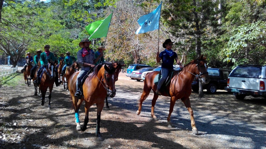 People riding horses in El Kabayo Stables People riding horses in El Kabayo Stables