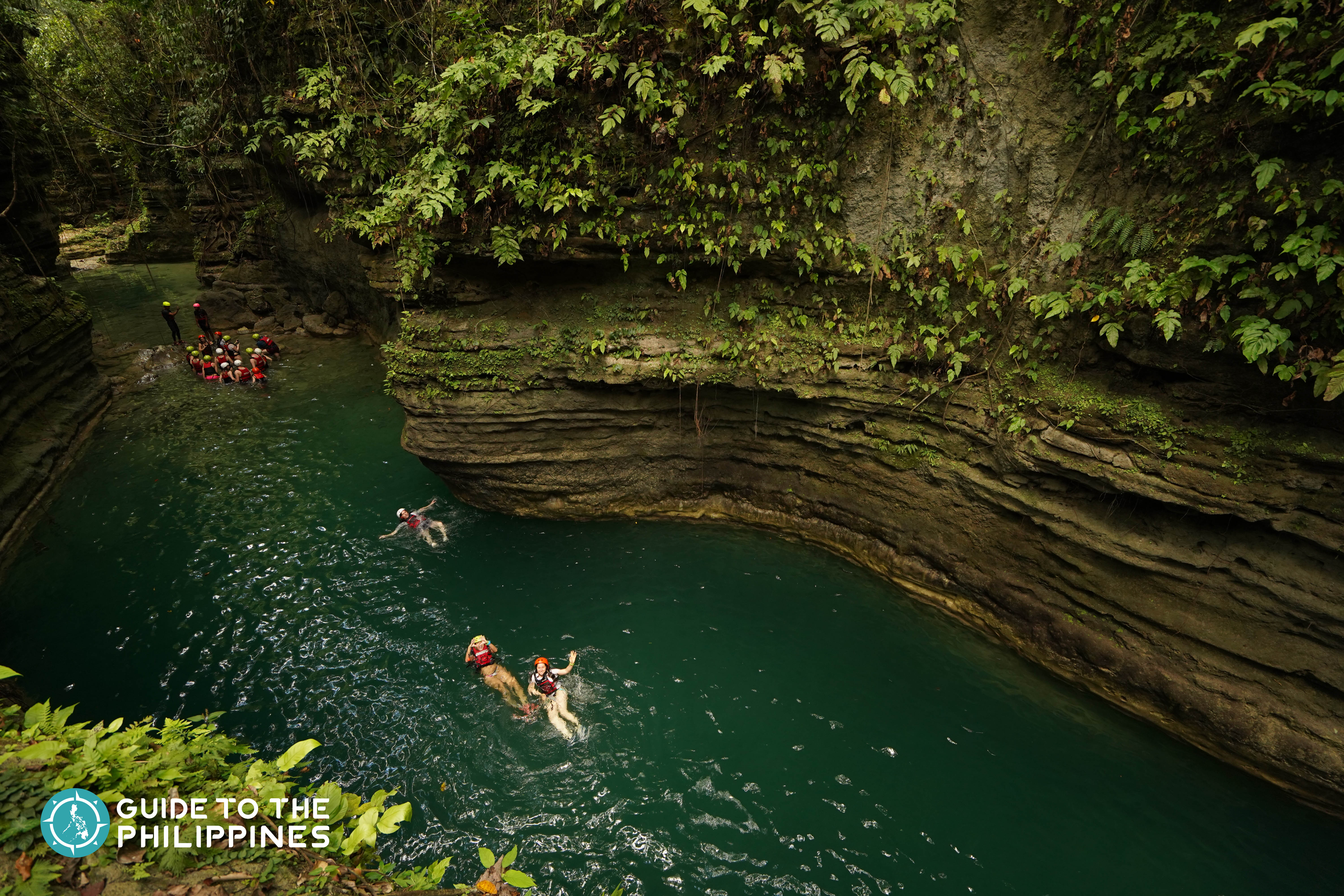 Travelers having a blast in the gorgeous gorges during their Kawasan Falls canyoneering tour.