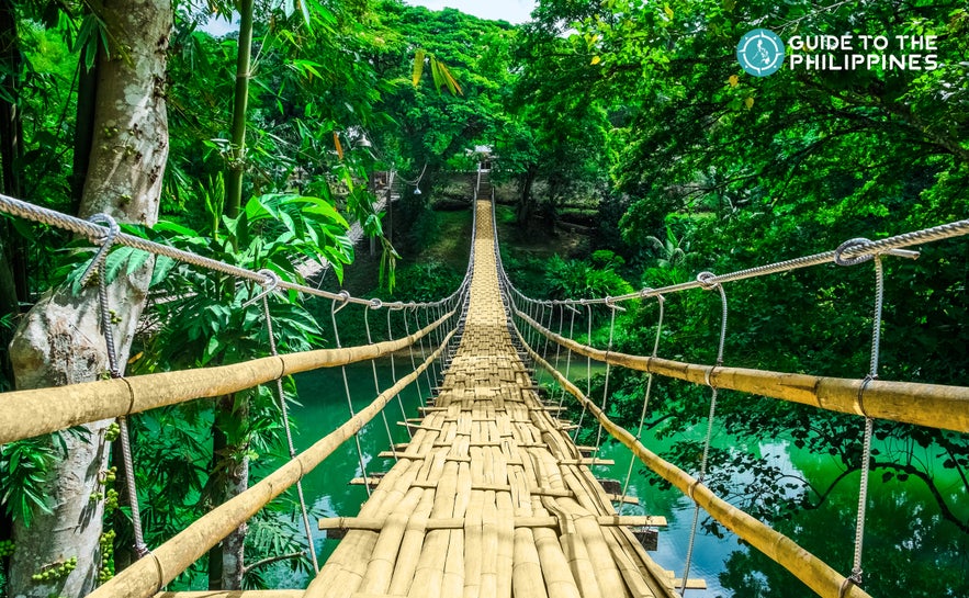 Tigbao Hanging Bridge is made of woven bamboo straps and stretches over a gently flowing river Tigbao Hanging Bridge is made of woven bamboo straps and stretches over a gently flowing river