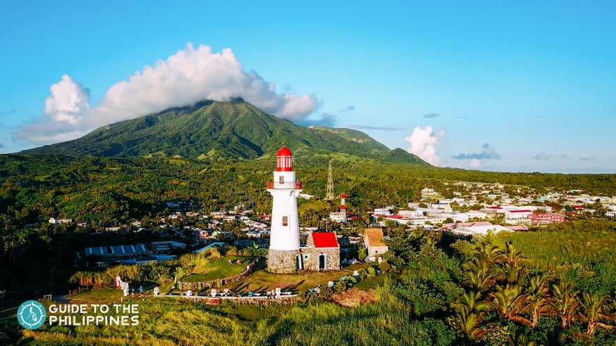 Sunset view of Mt. Iraya featuring the Basco Lighthouse of Batanes Sunset view of Mt. Iraya featuring the Basco Lighthouse of Batanes