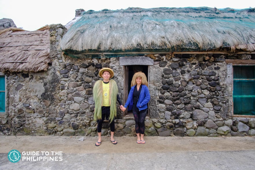 Travelers in front of a typical stone house in Savidug, Batanes Travelers in front of a typical stone house in Savidug, Batanes
