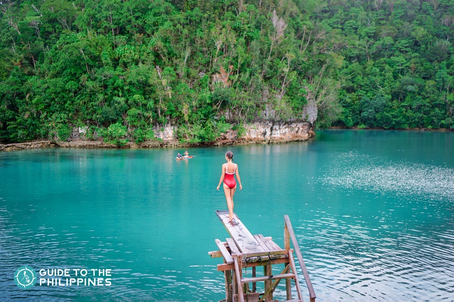 Girl about to jump off into the Sugba Lagoon of Siargao Girl about to jump off into the Sugba Lagoon of Siargao