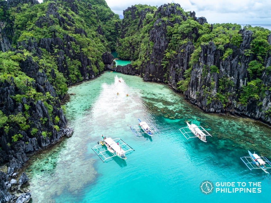 Palawan's limestone karst, white sand beach, and turquoise waters Palawan's limestone karst, white sand beach, and turquoise waters
