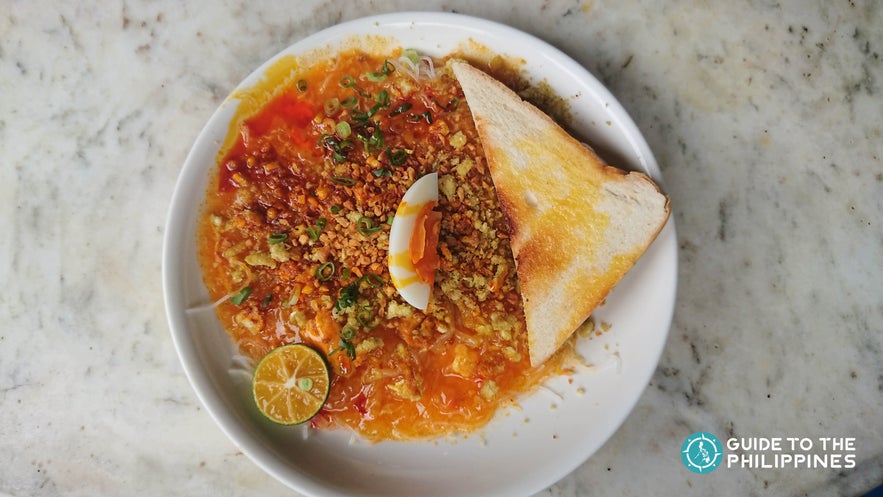 Pancit Palabok with half loaf bread in the Philippines Pancit Palabok with half loaf bread in the Philippines