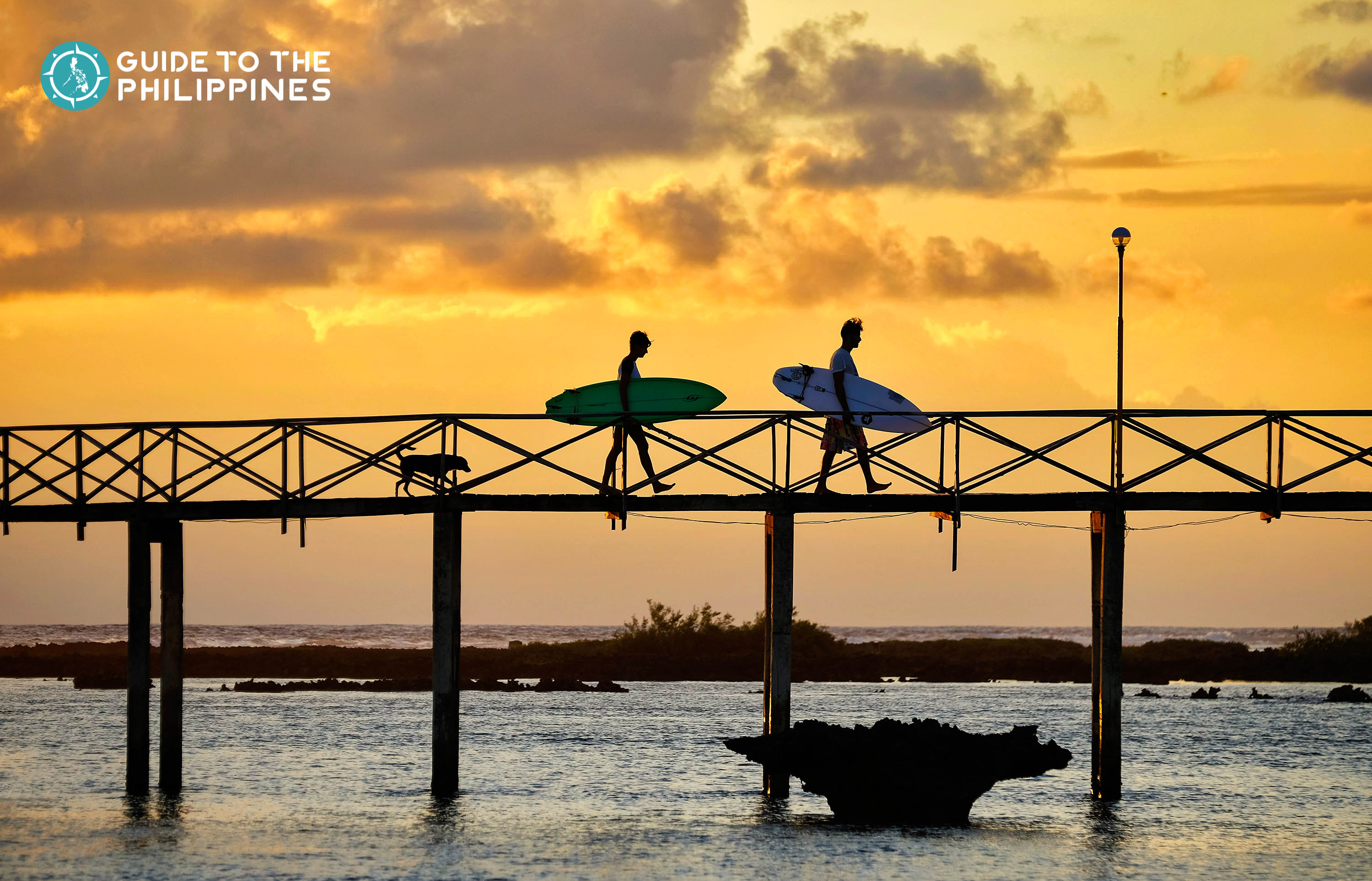 Surfers and sunset at Cloud 9 in Siargao Island