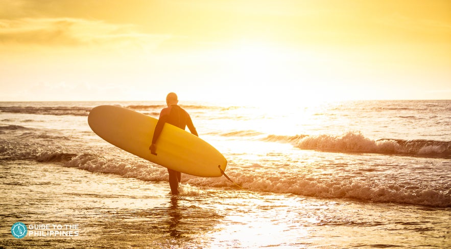 Surfer walking on the beach Surfer walking on the beach