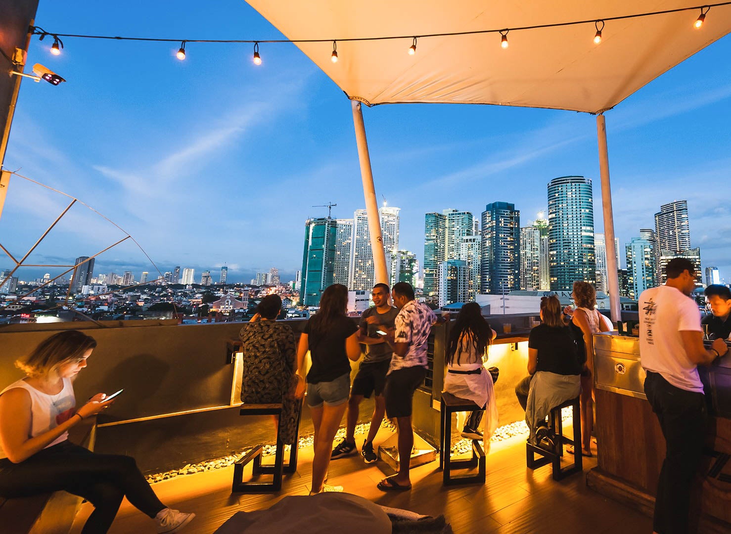 People having drinks at Z Hostel's rooftop bar in Poblacion, Makati
