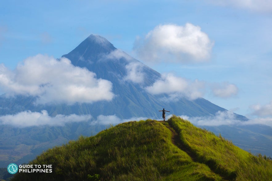 Hiker overlooking Mt. Mayon in Legazpi, Albay Philippines Hiker overlooking Mt. Mayon in Legazpi, Albay Philippines