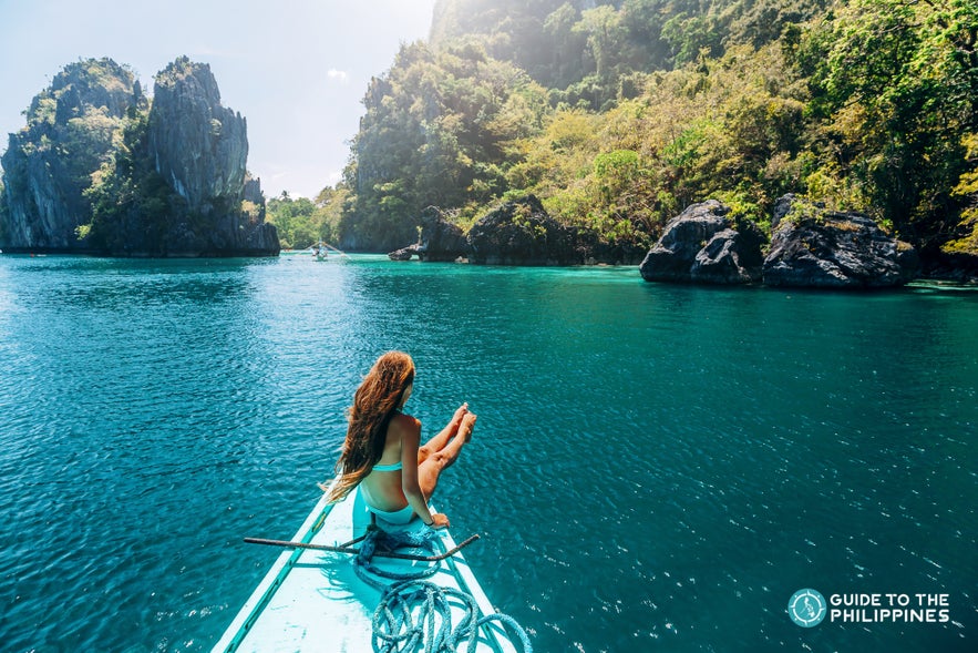 Woman traveler enjoying island hopping in El Nido, Palawan, Philippines Woman traveler enjoying island hopping in El Nido, Palawan, Philippines