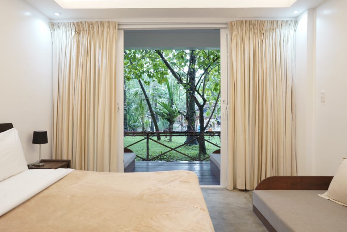 Deluxe room bedroon in Kermit Surf Resort in Siargao