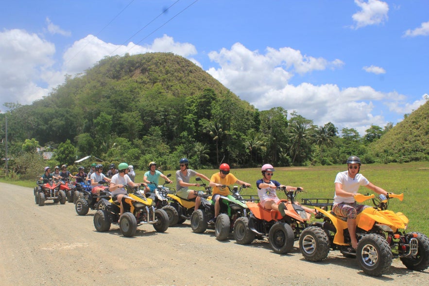 Group of travelers ready for their Chocolate Hills ATV adventure in Bohol, Philippines Group of travelers ready for their Chocolate Hills ATV adventure in Bohol, Philippines