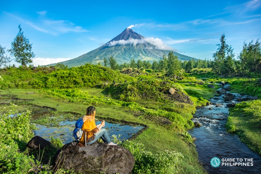 A girl looking at the wonderful view of Mayon Volcano A girl looking at the wonderful view of Mayon Volcano