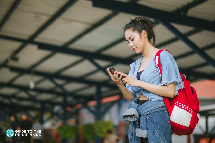Girl checking her phone in the Philippines Girl checking her phone in the Philippines