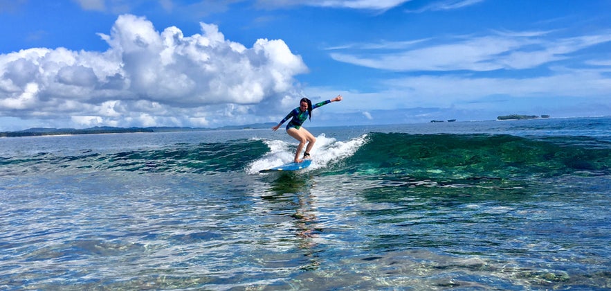 Girl surfing at Siargao surf spot Girl surfing at Siargao surf spot
