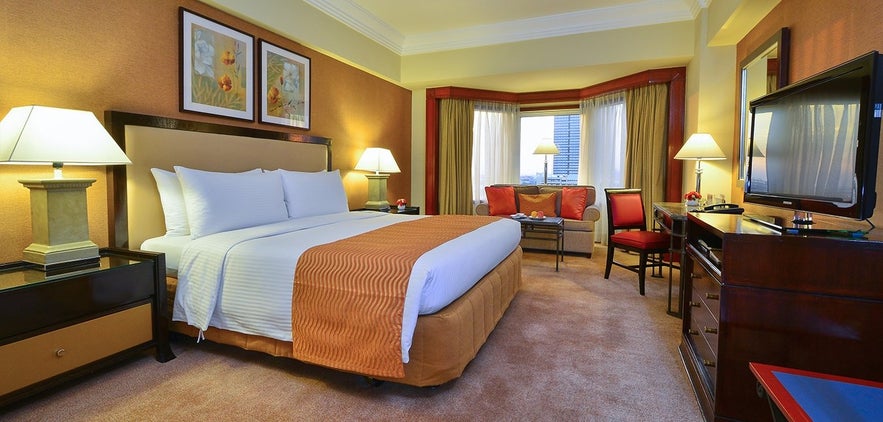 A bedroom of the 5-star Diamond Hotel Manila A bedroom of the 5-star Diamond Hotel Manila