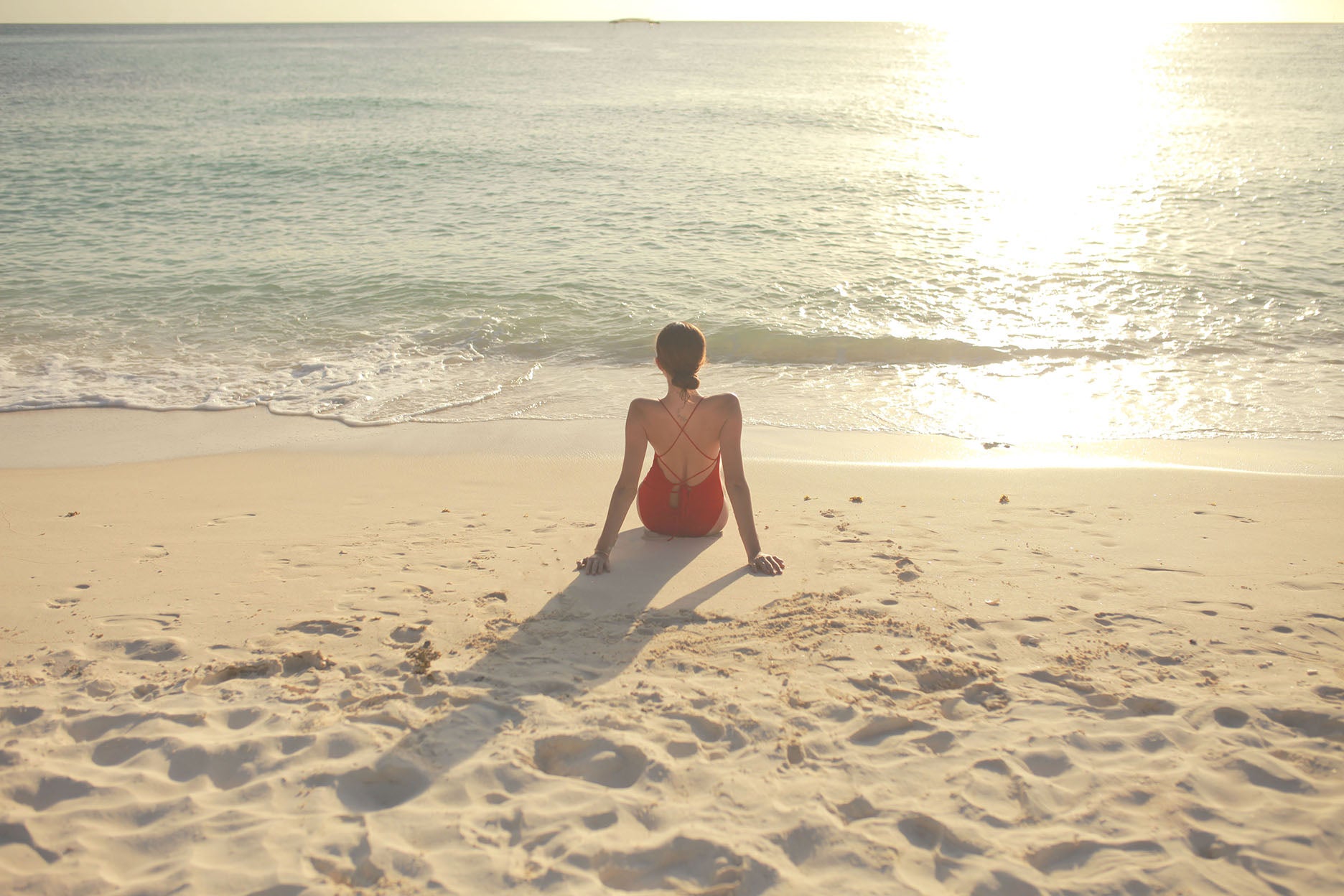 A girl watching the sunset in front of the beach in Crimson Resort and Spa