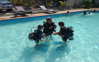 Dive instructor and children in the pool of Haka Dive Center