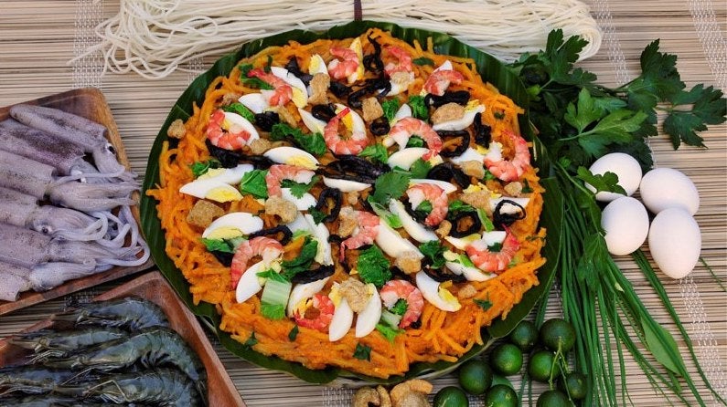 A big serving of pancit malabon topped with egg and shrimp A big serving of pancit malabon topped with egg and shrimp