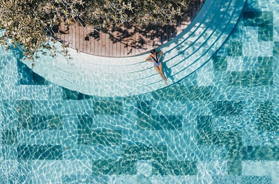 Woman enjoying the sun in one of Amorita Resort 's pool