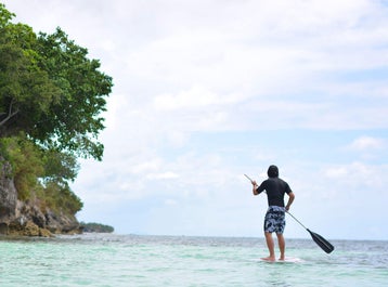 Man enjoying the stand up paddle on a sunny day at Amorita