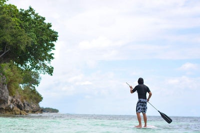 Man enjoying the stand up paddle on a sunny day at Amorita