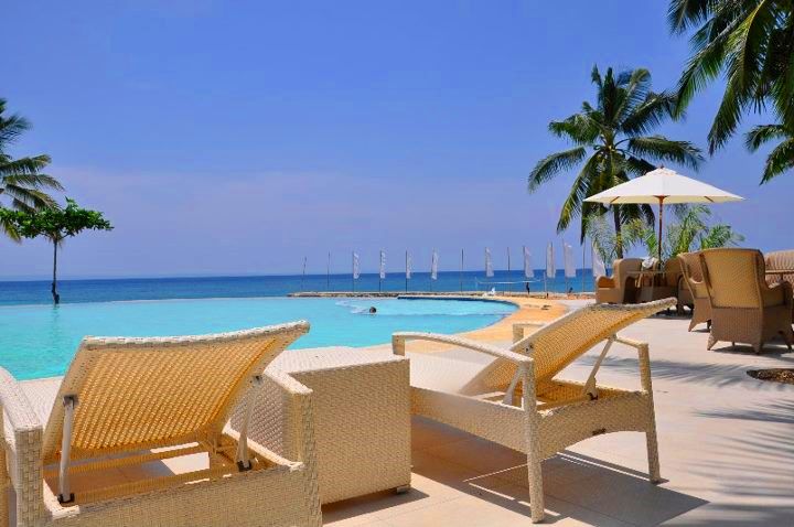 Lounge chairs by the pool in Mangodlong Paradise Beach Resort