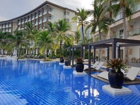 Pool area with palm trees in Dusit Mactan Resort