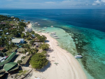 Boats docked on the shores of Pamilacan Island in Bohol