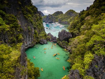 Several kayaks going around Miniloc Island in Palawan