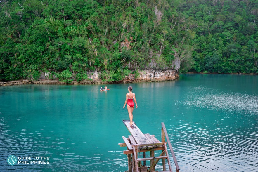 A girl about to jump from a diving board in Sugba Lagoon, Siargao A girl about to jump from a diving board in Sugba Lagoon, Siargao