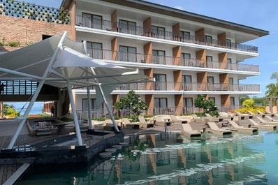 Mini bar and lounge chairs surrounding the pool area in Modala Resort