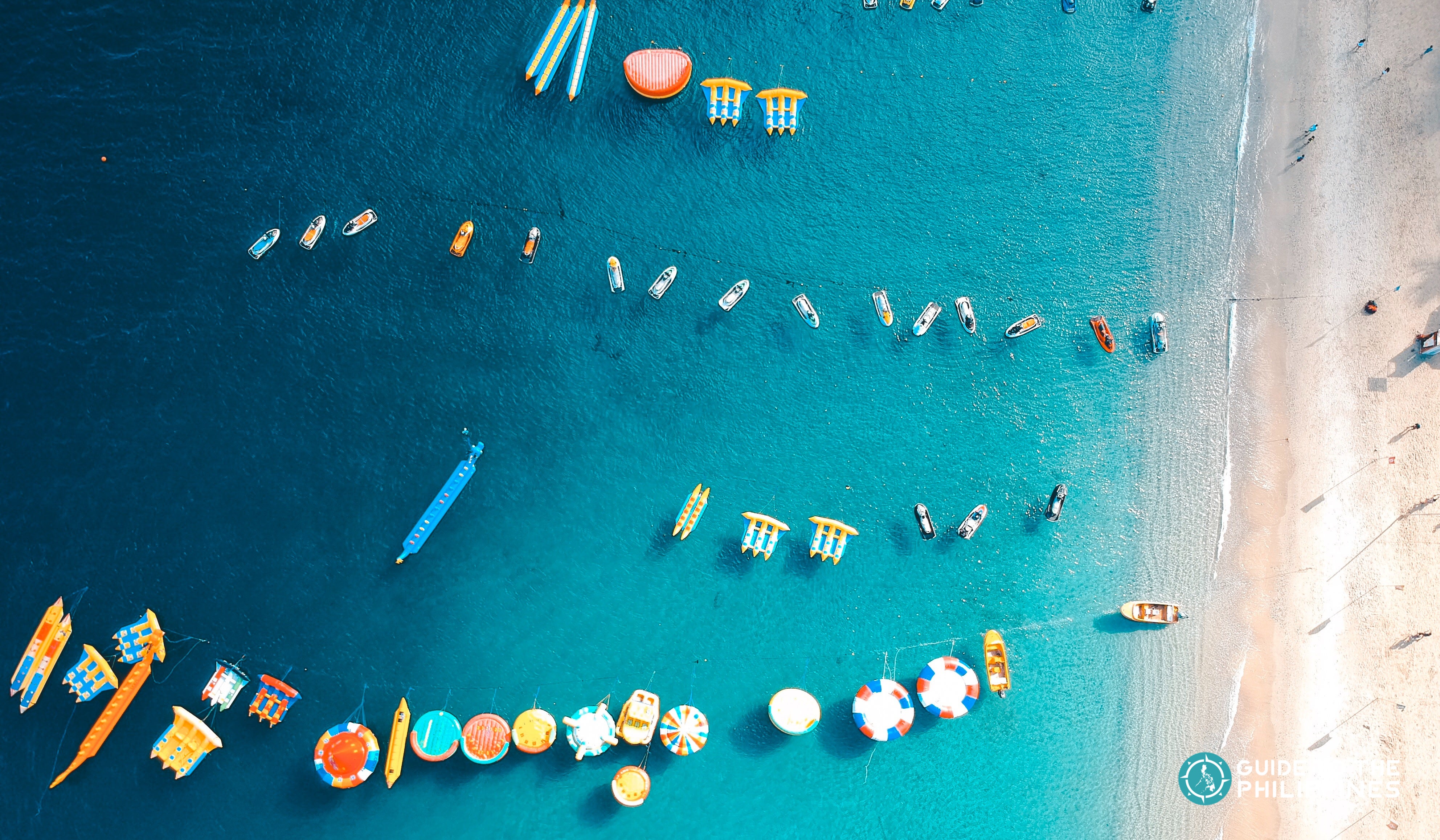 Floaters and water activities in White Beach, Puerto Galera