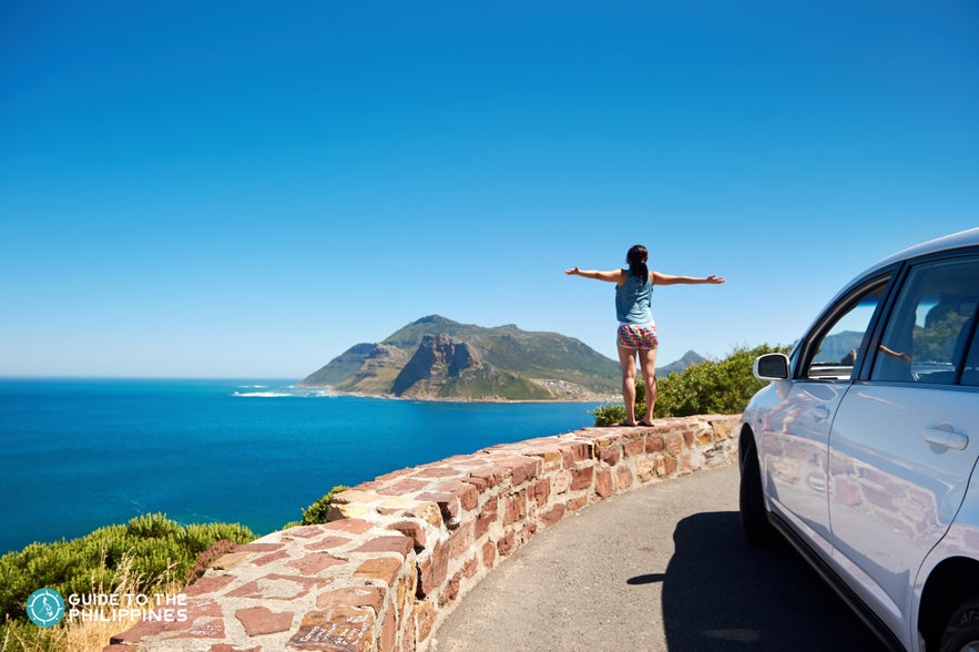 A girl enjoying the roadside view A girl enjoying the roadside view