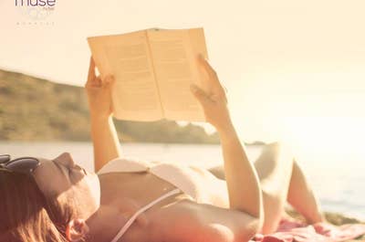 Woman reading a book at sunset at The Muse Hotel