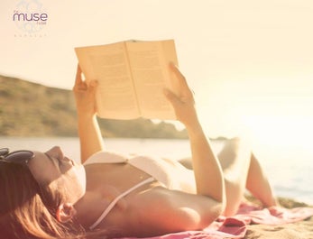 Woman reading a book at sunset at The Muse Hotel