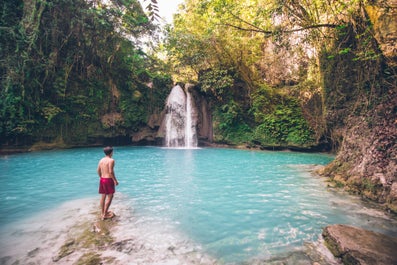 A man enjoying the view of Kawasan Falls