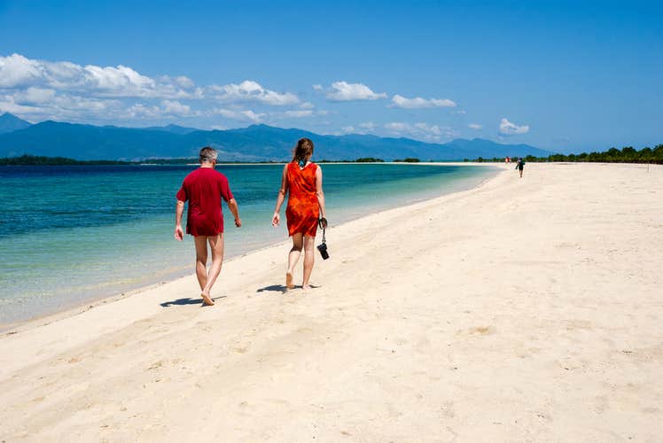 A couple walking along the shores of Honda Bay