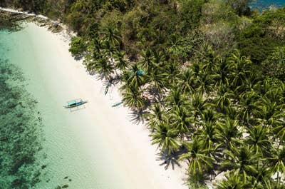Clear waters and white sand beach at Port Barton Palawan