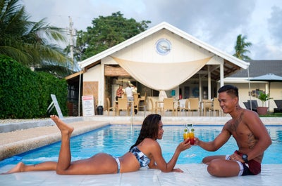 A couple enjoying their time at the pool of Cebu Seaview Dive Resort