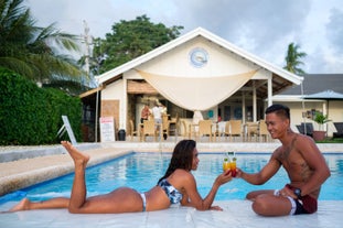 A couple drinking by the pool of Cebu Seaview Dive Resort