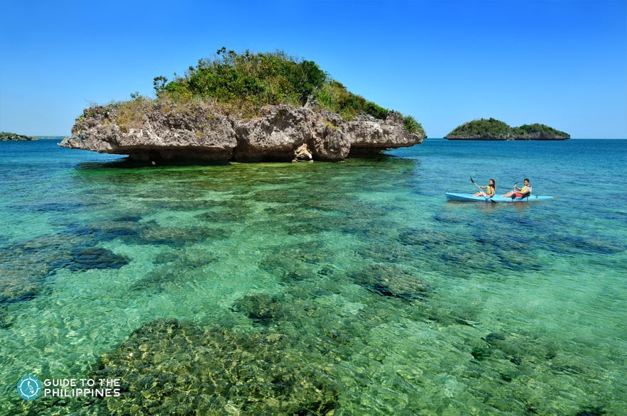 Couple Kayaking by the Hundred Islands, Pangasinan Couple Kayaking by the Hundred Islands, Pangasinan