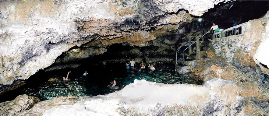 Guest swim in a natural pool inside the Enchanted Cave Guest swim in a natural pool inside the Enchanted Cave