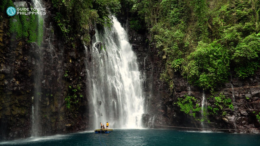 People standing on raft by Tinago Falls in Iligan City People standing on raft by Tinago Falls in Iligan City