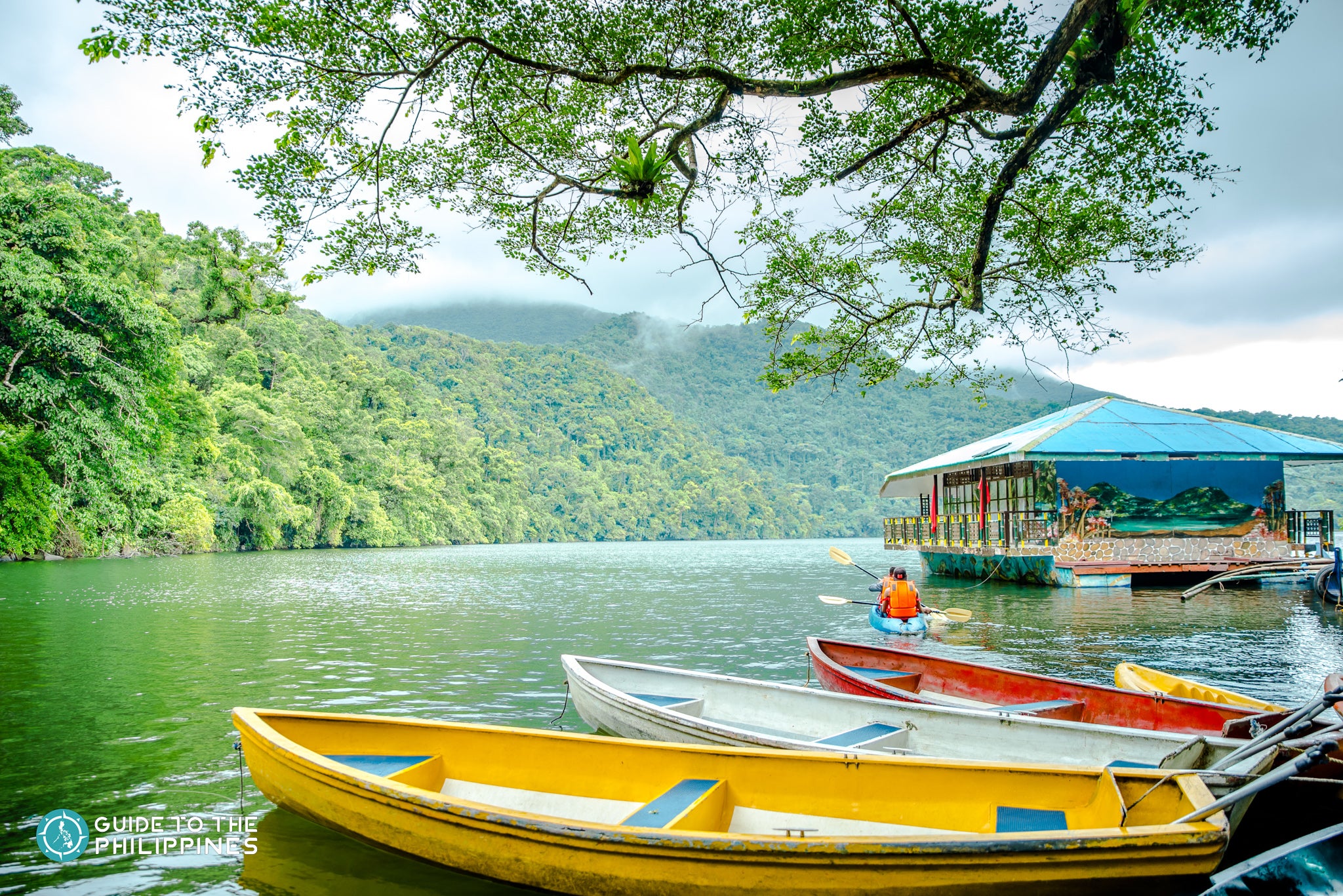Boats and a floating hut on Bulusan Lake, Bicol