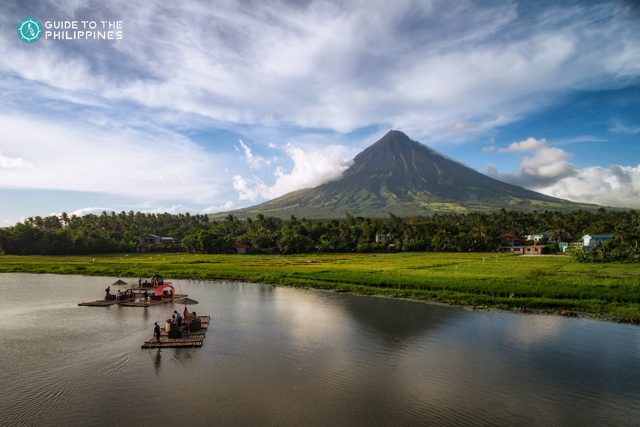 Tourists float on rafts on Sumlang Lake near Mayon Volcano