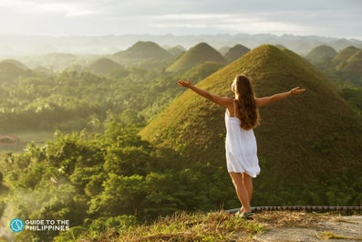 A woman enjoying the sunset at Chocolate hills in Bohol